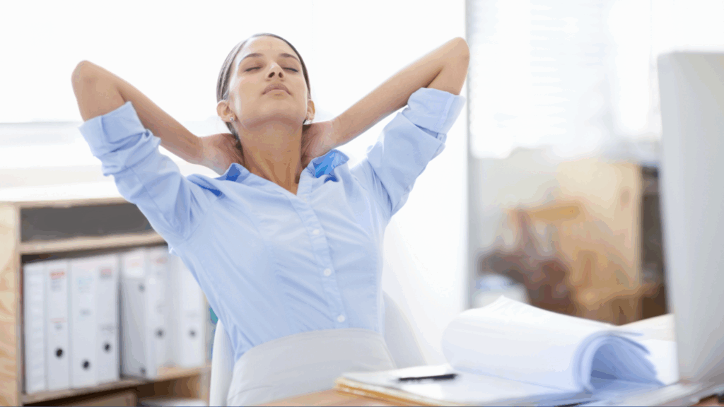 A lady sitting at desk, leaning back due to neck pain